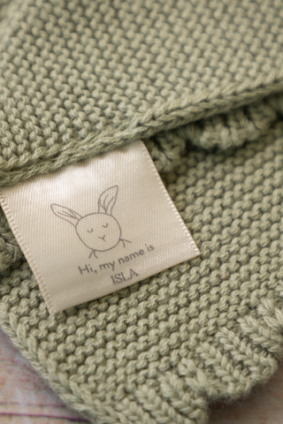Close up of Organic Cotton Bunny Comforter label which reads 'Hi, my name is Isla'