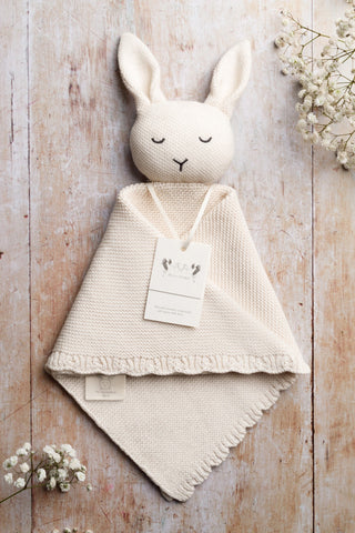 Organic Cotton Bunny comforter on a wooden backdrop 