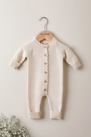 Organic Cotton Moss Stitch Baby Romper on a Hanger with Gypsophilia in corner
