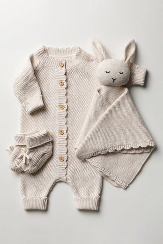 Gift Bundle containing Knitted Baby Romper, Baby Bunny Comforter and Baby Booties on a white backdrop