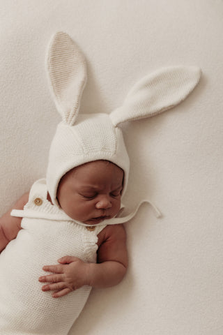 Baby wearing knitted bunny bonnet