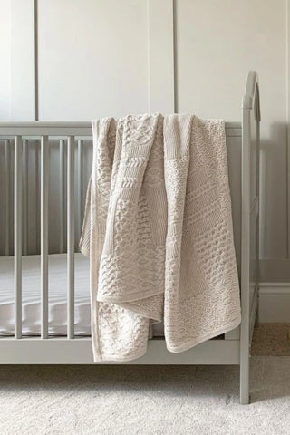 Large Cable Knit Blanket on a cot in a neutral nursery