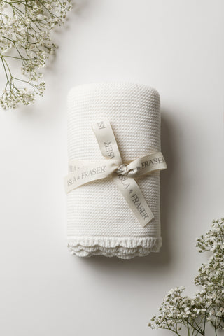 White Knitted Baby Blanket tied with an Isla & Fraser ribbon