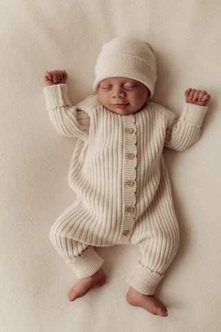 Sleeping Baby in Knitted Hat and Romper