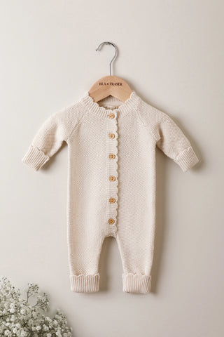 Knitted Baby Romper on a wooden Isla & Fraser hanger