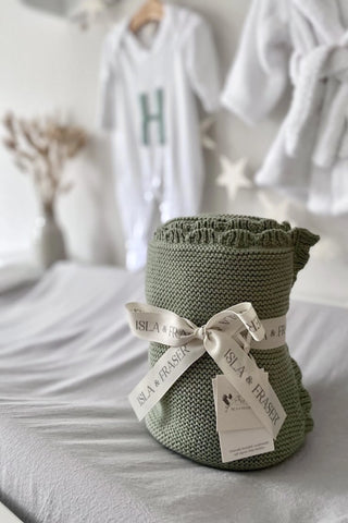 Sage Green Knitted Baby Blanket on changing mat