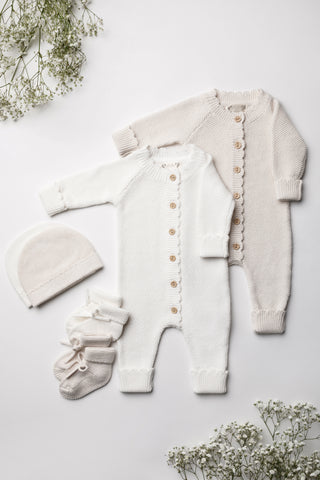 Neutral knitted baby gift set of rompers, hats, and booties
