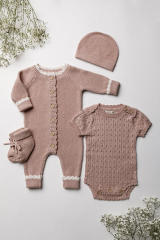 Knitted pink baby gift set flatlay