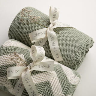 sage green Isla & Fraser baby blankets tied with a cream ribbon