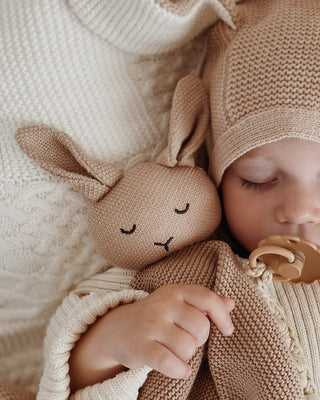 Sleeping baby with bunny comforter 
