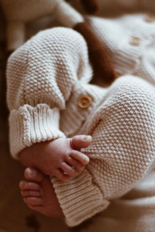 A close up of Newborn Baby toes, wearing Organic Cotton Moss Stitch Baby Romper
