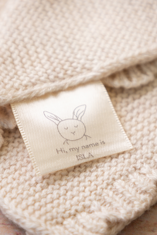 Close up of Organic Cotton Bunny Comforter Label which reads 'Hi, my name is Isla'