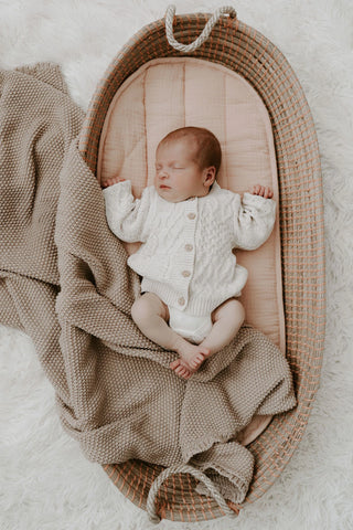 Sleeping Baby in a Basket wearing Organic Cotton Cable Knit Baby Cardigan