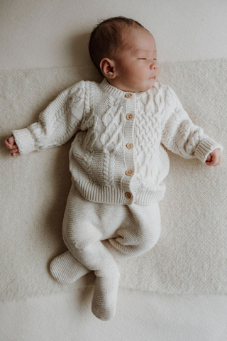 Sleeping Baby wearing Organic Cotton Cable Knit Baby Cardigan and Dungarees