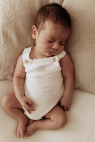 Sleeping baby wearing an Organic Cotton Milk Romper