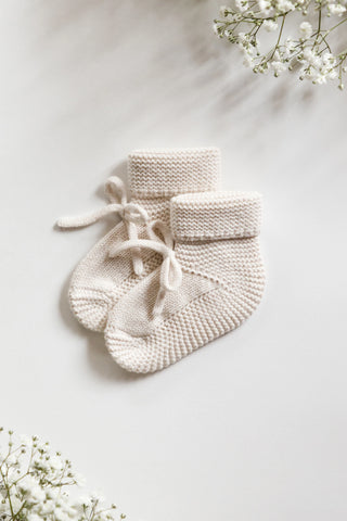 Knitted Bow Booties on a white backdrop 