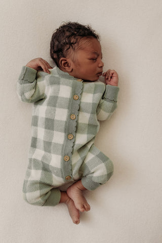 baby wearing sage and cream checkered knitted romper
