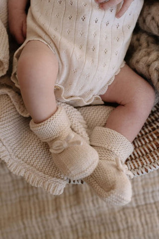 Knitted baby booties with bow