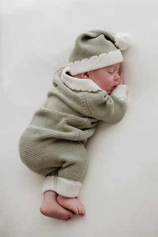 Baby in green and white Christmas elf outfit