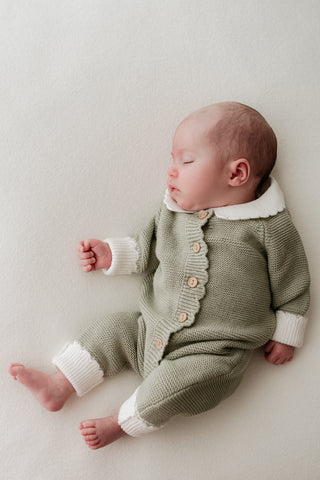 Baby in green and white Christmas elf outfit