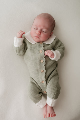 Baby in green and white Christmas elf outfit
