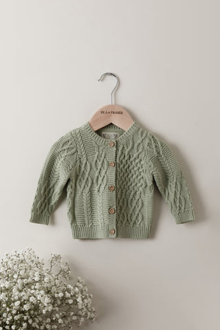 Sage green cable knit baby cardigan on Isla & Fraser hanger 