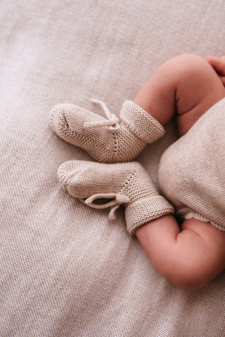 Baby wearing knitted bow booties