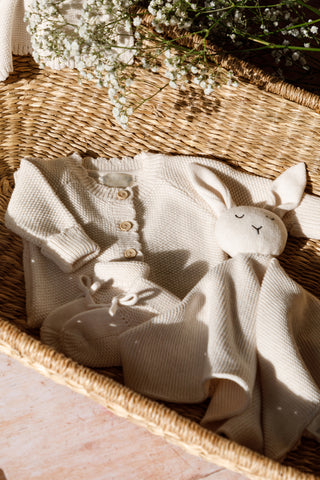 Baby Basket with baby knitwear and flowers