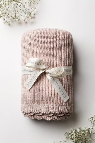 Pink knitted baby blanket with a scalloped edge and tied with an Isla and Fraser ribbon