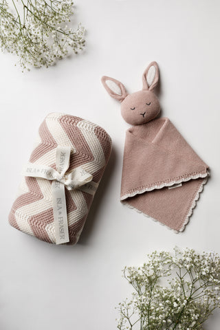 Pink and cream stripe knit blanket tied with an Isla & Fraser ribbon and a pink knitted bunny comforter