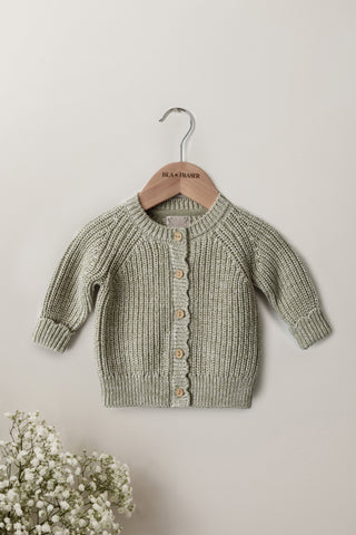 Sage Green knitted baby cardigan on a wooden Isla & Fraser hanger