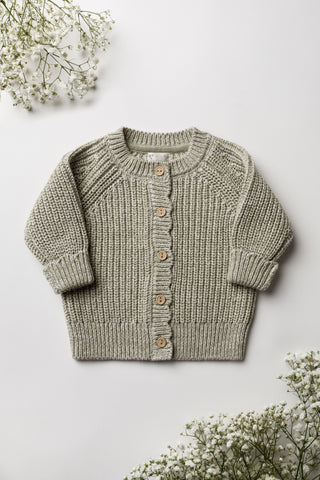 Sage green knitted baby cardigan on a white backdrop