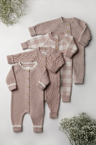 Four knitted pink baby rompers 