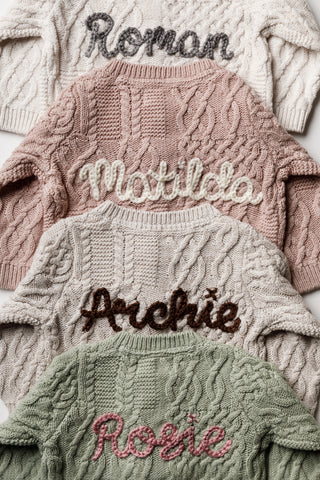 Hand embroidered personalised baby cardigans in a cable knit