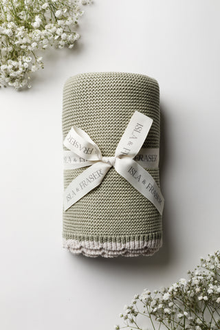 Sage knitted baby blanket tied with Isla & Fraser ribbon