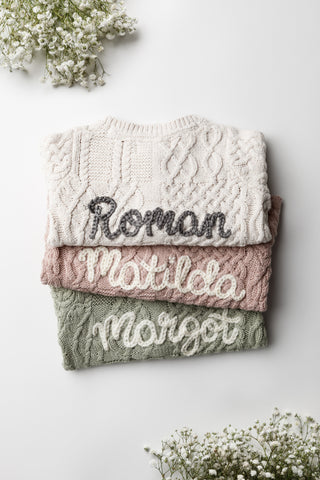 Embroidered personalised baby cardigans in a cable knit