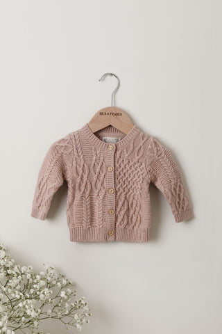 Rose pink cable knit baby cardigan on Isla & Fraser hanger 