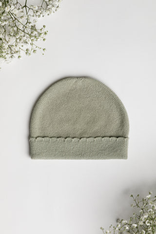 Sage green knitted baby hat with a scalloped turn back