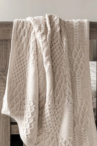 Cable Knit Beige Baby Blanket over cot