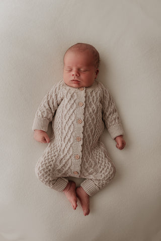 Baby wearing cable knitted grey romper