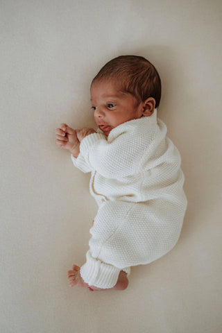 Newborn baby in white romper