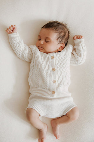 Sleeping Baby in Knitted Cardigan and Bloomers 