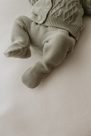 Baby wearing sage green knitted leggings