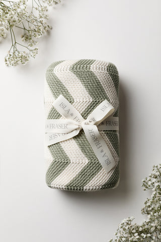 Sage and Cream Chevron Knitted Baby Blanket tied with an Isla & Fraser ribbon