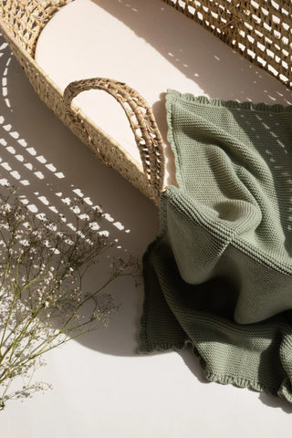 Sage Scallop Knitted Baby Blanket in Moses Basket