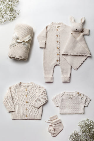Neutral Knitted Baby Gift Set flatlay: blanket, romper, bunny comforter, cardigan, bodysuit, and booties