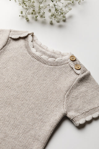 Knitted grey baby bodysuit with buttons at shoulder