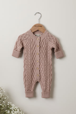 Cable knit baby romper in pink on Isla & Fraser hanger