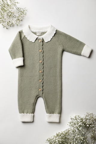 Green knitted romper with a white contrast collar and cuffs