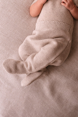 Baby wearing grey knitted outfit 